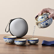 Portable Blue And White Beige Ru Kiln Travel Tea Set by eprolo, highlighting the action of pouring tea from a decorated teapot into beautifully designed cups.