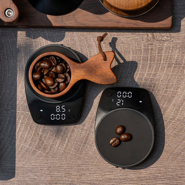 Mini Electronic Coffee Scale by eprolo weighing coffee beans in a decorative wooden bowl, ideal for perfect brewing.