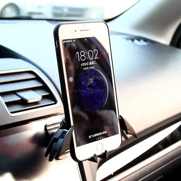 Eprolo Batman Gravity Buckle Car Phone Holder holding a smartphone on a car dashboard, ideal for drivers needing hands-free navigation.